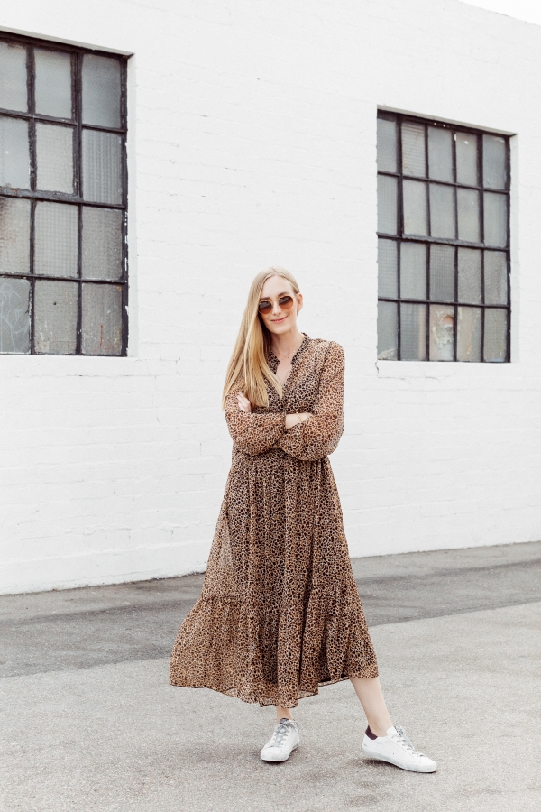Kimberly Lapides of eatsleepwear wearing a long leopard maxi dress from h&m and golden goose sneakers with ray-ban sunglasses.