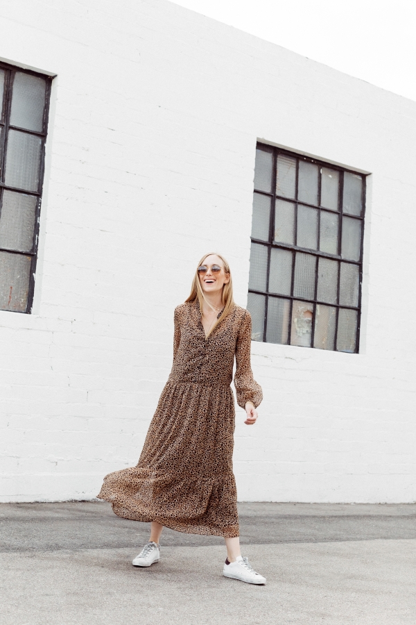 Kimberly Lapides of eatsleepwear wearing a long leopard maxi dress from h&m and golden goose sneakers with ray-ban sunglasses.