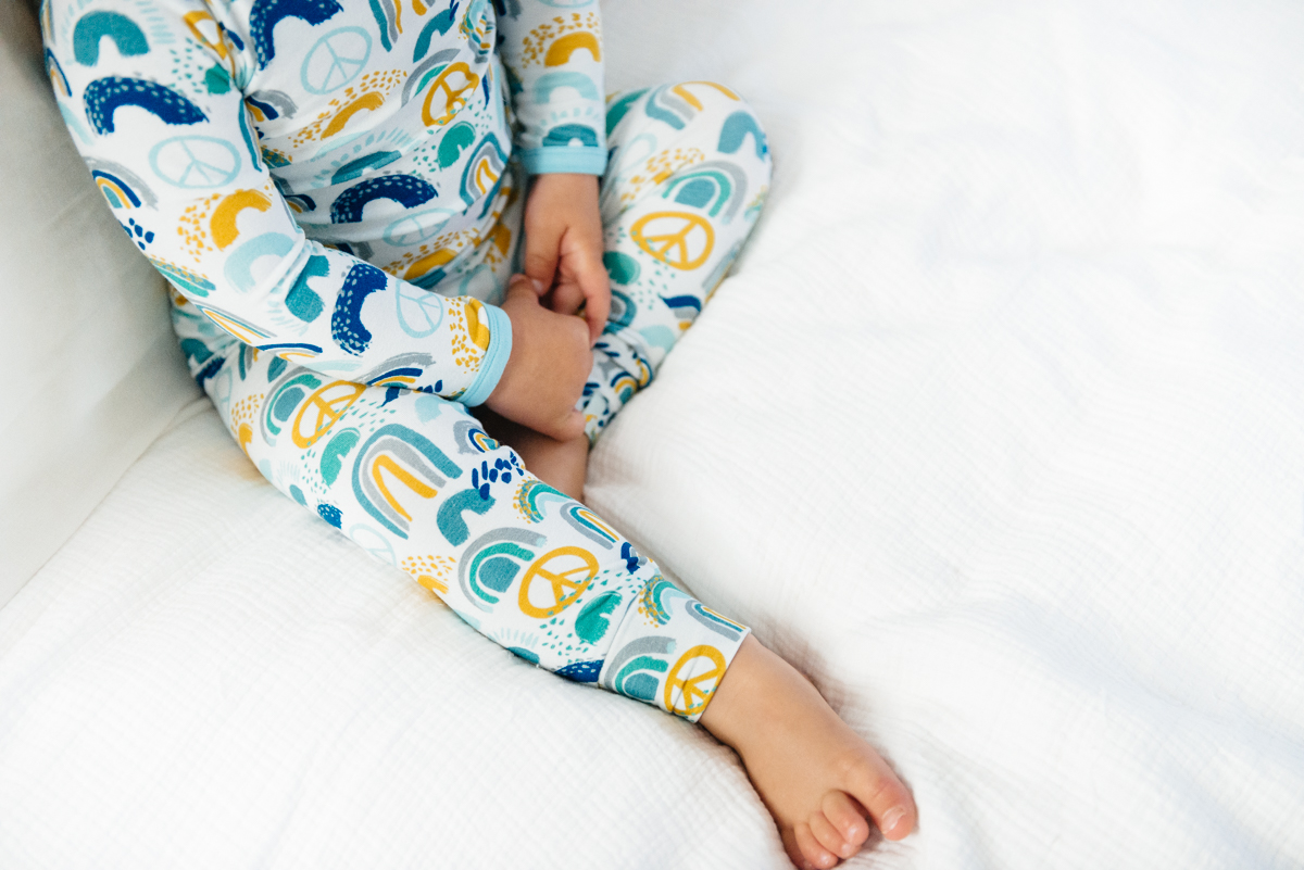 close up image of clover baby & kids rainbow print pajamas