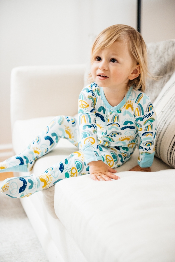 toddler on couch wearing Clover Baby & Kids pajamas celebrating Rainbow Baby, IVF, and Infertility