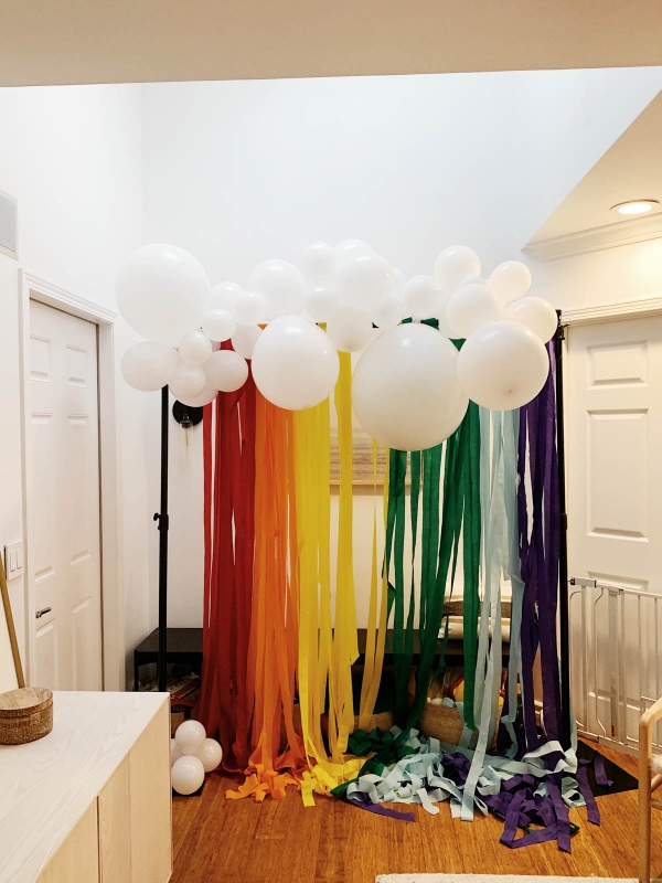 DIY Rainbow and cloud balloon arch with streamer backdrop for Trolls Themed Birthday