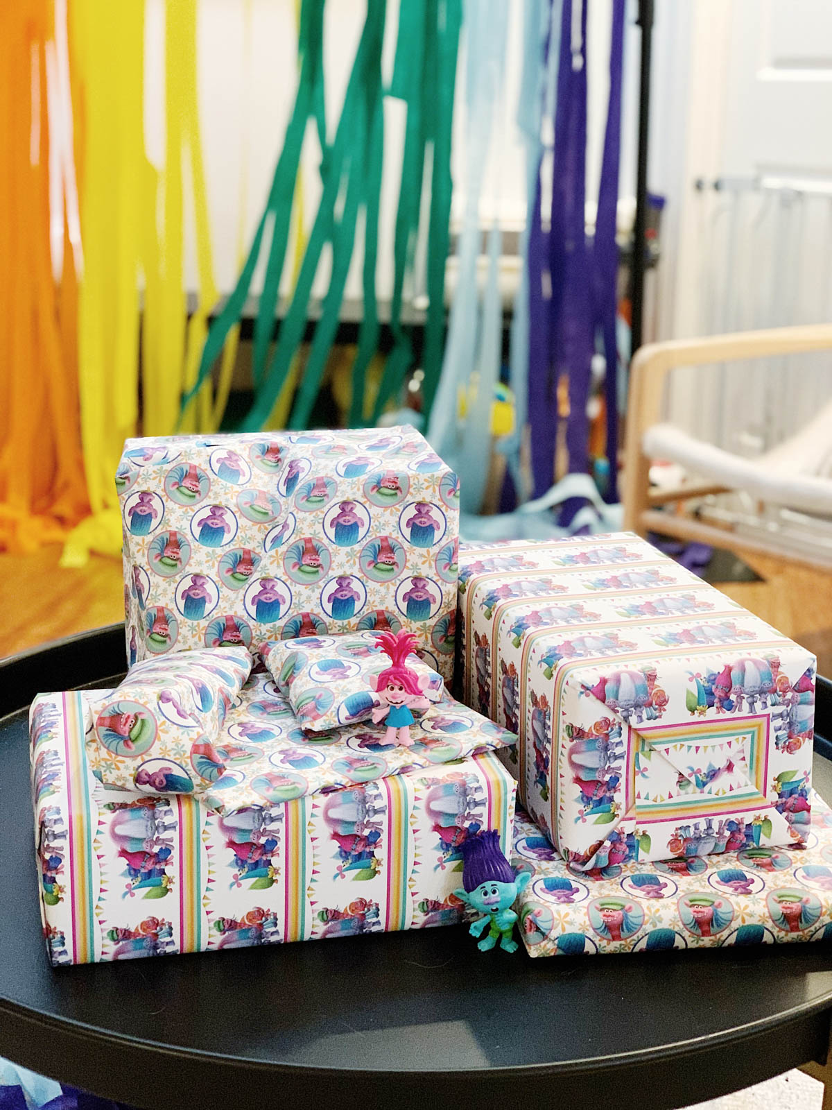 Trolls themed birthday decor showing  custom trolls wrapping paper