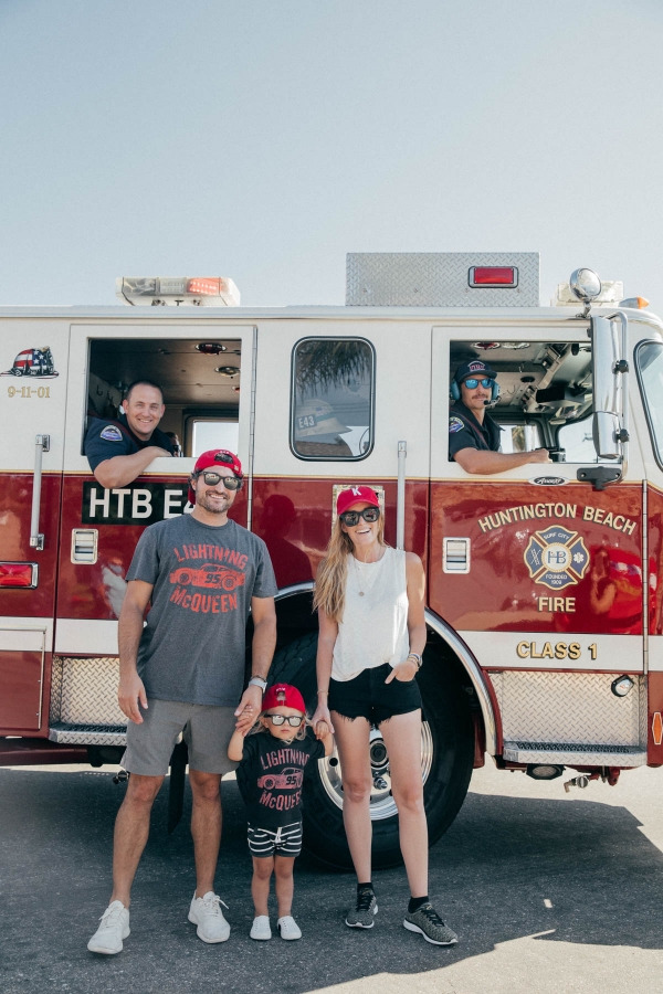 Family posing with Firetruck at Drive By Birthday Party at Disney Pixar Cars themed birthday
