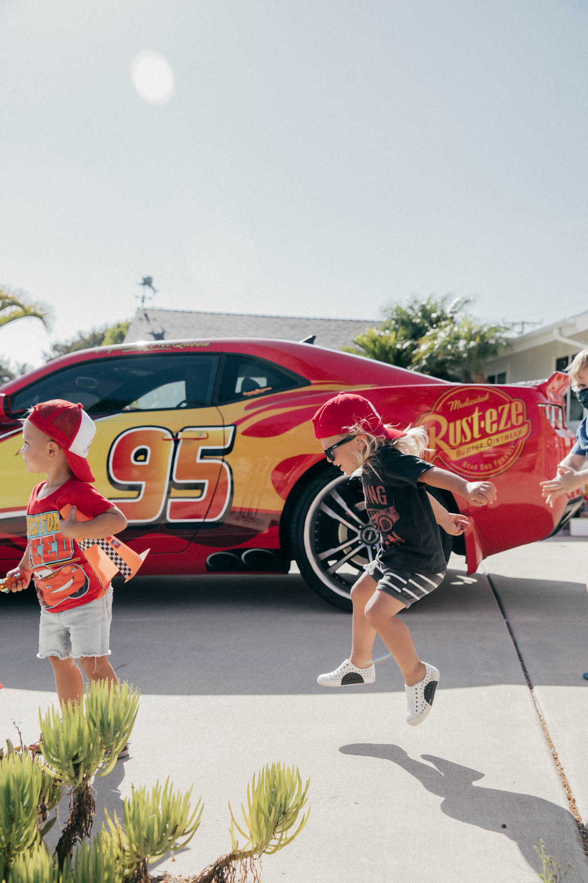 Toddlers dancing in front of Lightning McQueen Impersonator at Disney Pixar Cars themed birthday