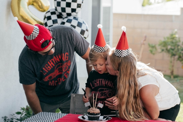 Singing Happy Birthday with Cupcake and race car theme decorations at Disney Pixar Cars themed birthday