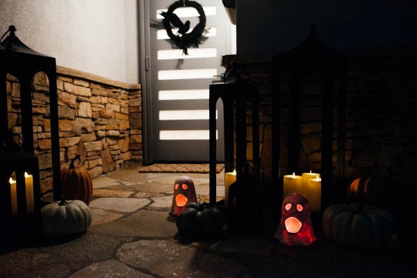 Fall & Halloween Decor For Patio & Yard with Lanterns, faux pumpkins, crow wreath and LED ghosts lit up at night