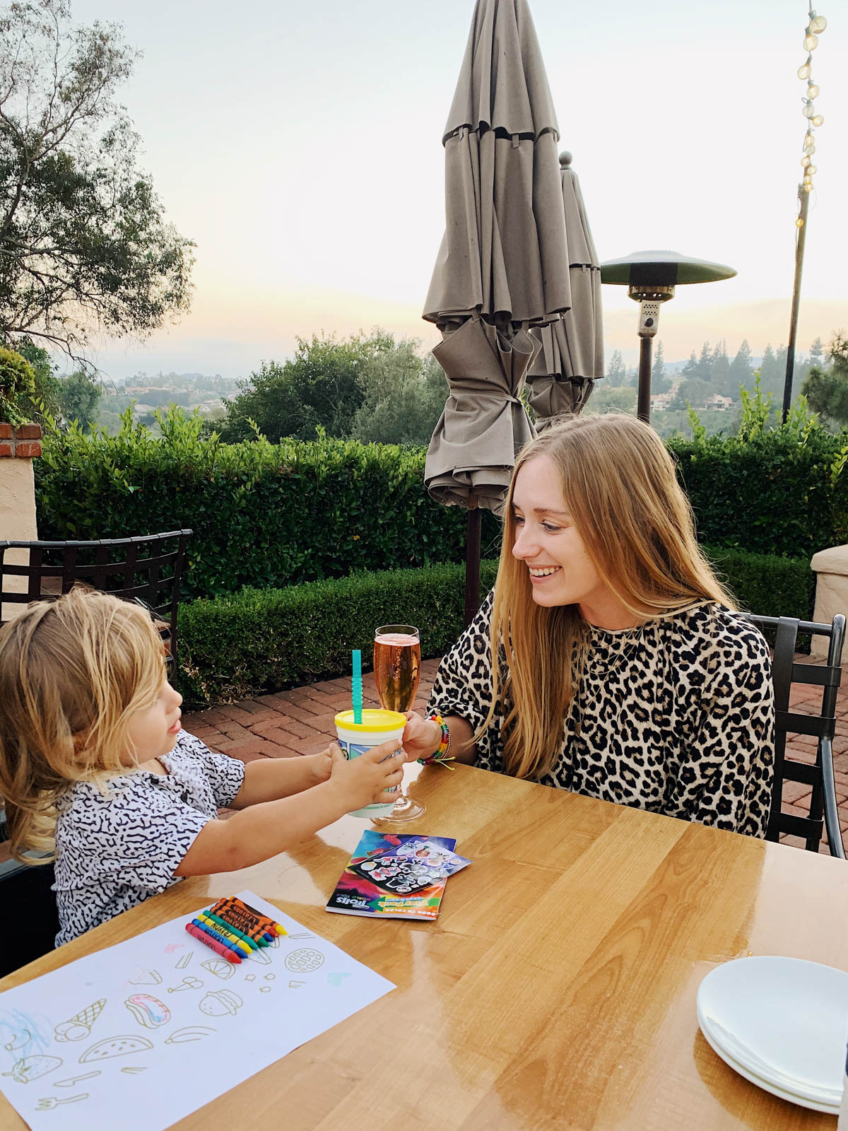 eatsleepwear goes on a family trip with toddler to Rancho Bernardo Inn showing mother and son at dinner outside