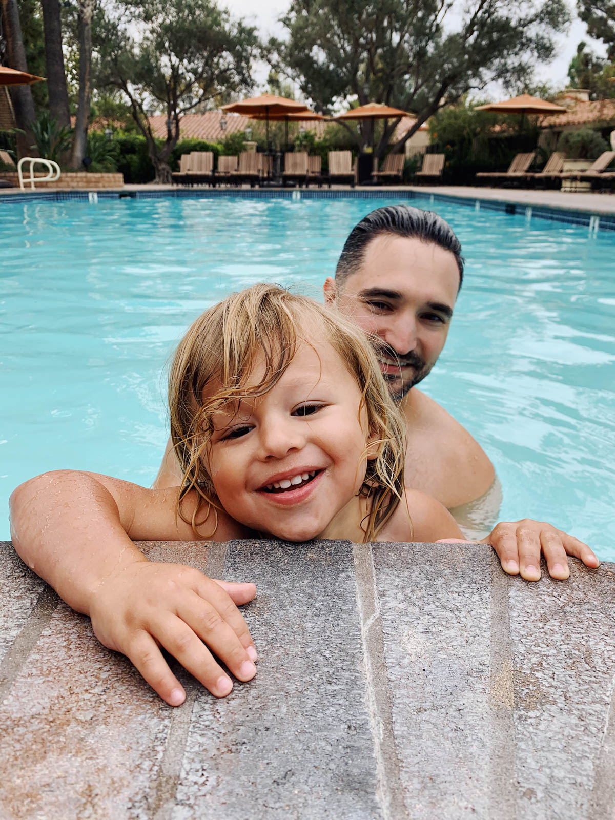 eatsleepwear goes on a family trip with toddler to Rancho Bernardo Inn showing father and son at the pool