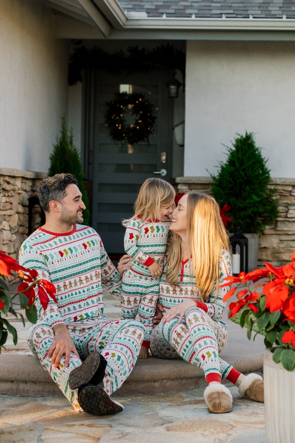 Family sitting outside in holiday Christmas pajamas