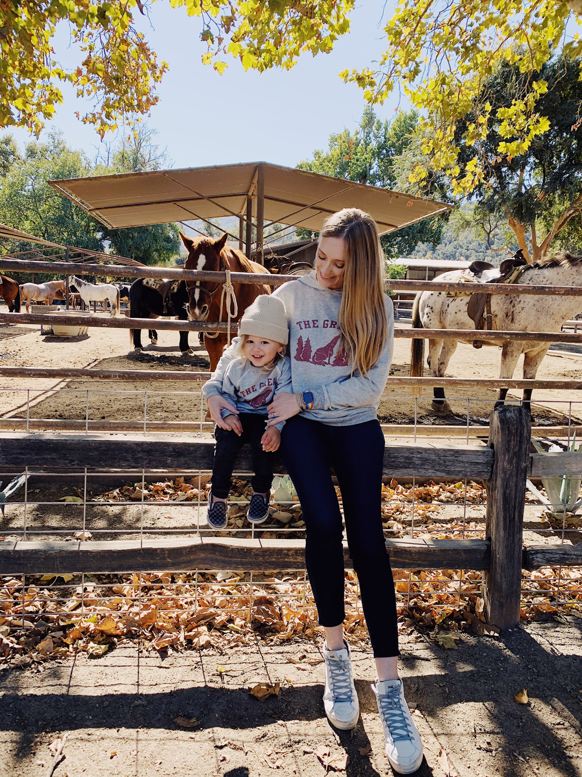 Mom and toddler in front of horses at Alisal Guest Ranch and Resort 