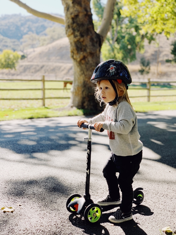 Toddler riding scooter at Alisal Guest Ranch and Resort 